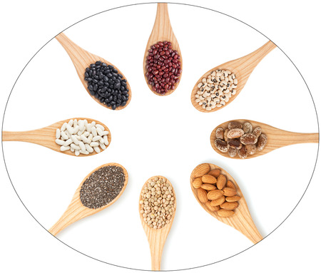 Grains, seeds and legumes on wooden spoons の写真素材