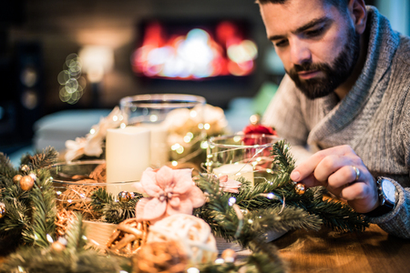 Bearded man decorating christmas table with bubblesの写真素材
