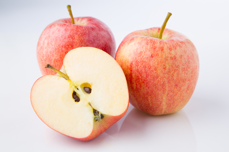 Fresh apples cut in half on white studio backgroundの写真素材