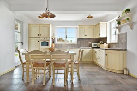 Warm retro styled kitchen and dinning room with panoramic windowの写真素材