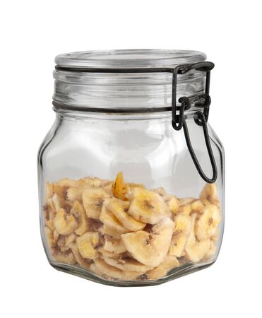 Dried sliced banana in mason jar, isolated on whiteの写真素材