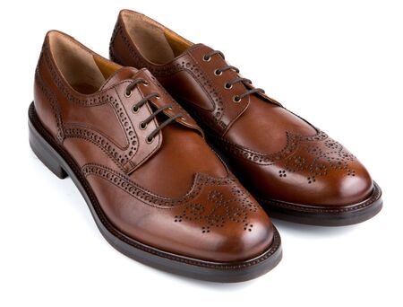 Brown leather male Oxfords shoes with Brogue isolated on whiteの写真素材