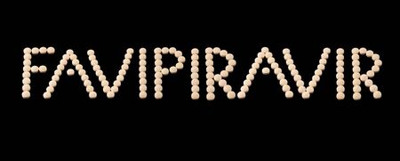 Favipiravir experimental drug for treating covid 19 written with pills on black backgroundの写真素材