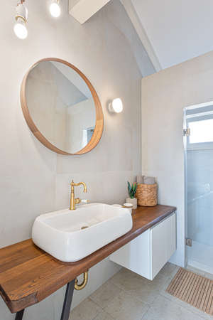 Bathroom vessel sink with golden color tap in rental apartmentの写真素材