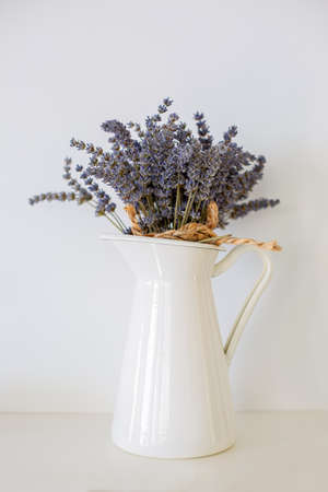 Bunch of dried lavender straws in a white tin vaseの写真素材