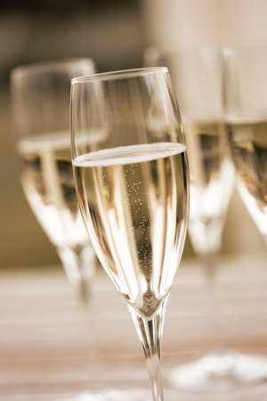 Festive photo of sparkling wine in glassesの写真素材
