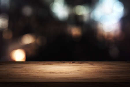 wooden table in front of blurred background of restaurantの写真素材