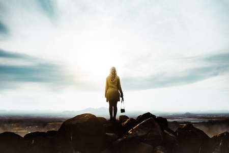 woman female photographer on top of the mountains with camera in hand.の写真素材