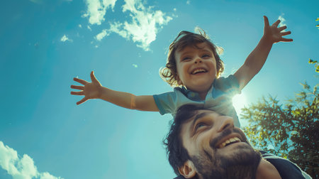 father with his son on his shoulders enjoying life with a big smileの素材