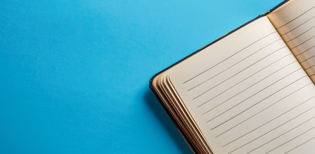 Closeup of a notebook on a blue copyspace backgroundの素材