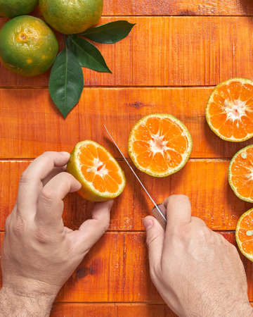 Chef cutting tangerine in half 1の写真素材