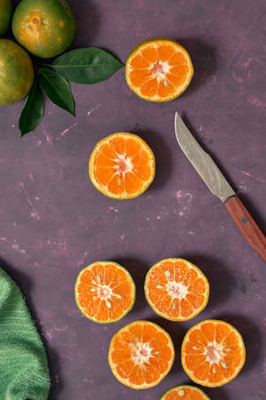 Tangerines cut in half on a rustic tableの写真素材