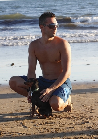 handsome young man walk on the beach a sunny dayの写真素材