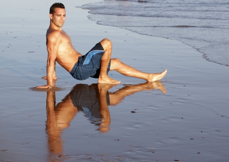 handsome young man walk on the beach a sunny dayの写真素材