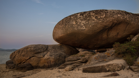 giant rock on the beach in galiciaの写真素材