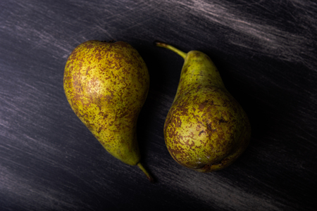 Two pears on a dark wood backgroundの写真素材