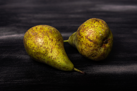 Two pears on a dark wood backgroundの写真素材