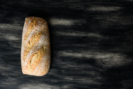 Loaf of bread on dark wooden backgroundの写真素材