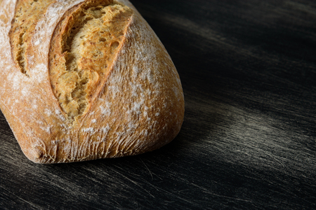 Loaf of bread on dark wooden backgroundの写真素材