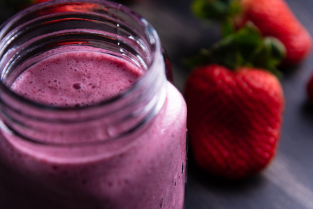 Strawberrie milkshake on dark wooden backgroundの写真素材