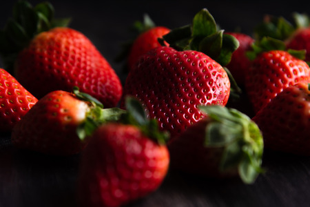 Strawberries on dark wooden backgroundの写真素材