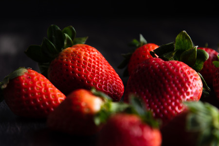 Strawberries on dark wooden backgroundの写真素材