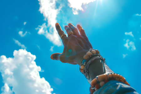 Hand with bracelets of a black person pointing towards the skyの素材