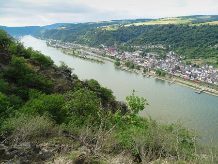 Oberwesel, Germany - Summer 2017: View from the Rheinsteig into the Rhine Valley and the town of Oberwesel. The main hiking trail has rocky alternatives that are really fun.の写真素材