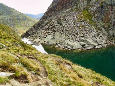 The Toma Lake in Switzerland is considered the source of the river Rhine, the first few kilometers it flows as a small stream down the rocks.の写真素材