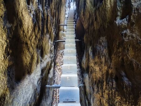 Famous stairway in the 'Kuhstall' (Saxony Switzerland) between narrow rocks.の写真素材