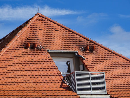 Balcony of an attic apartment with dirty chimneyの写真素材