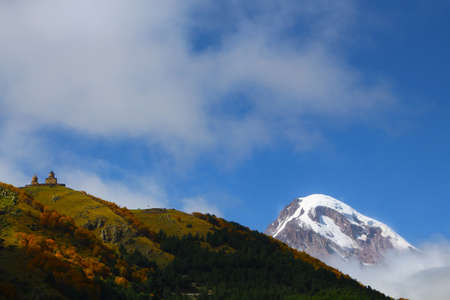 The Gergeti Trinity Church and Mount Kazbek in the Caucasus, Georgia, Georgiaの写真素材