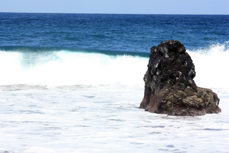 Rock in the surf Playa de Bollullo, Canary Islands, Spainの写真素材