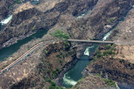 Africa, the Victoria Falls, Zimbabwe. The border bridge between Zambia and Zimbabwe photographed from the helicopter.の写真素材