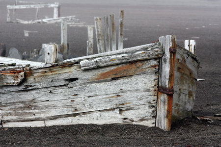 Old fishing boat on the beach, relics of an old whaling station on Deception Island in Antarcticaの写真素材