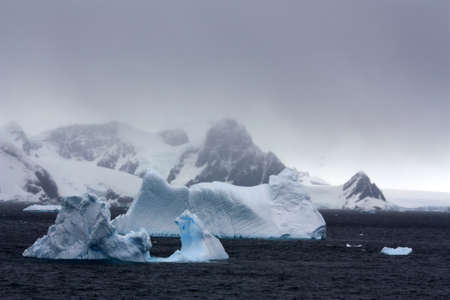 Iceberg in the bay on the Danco Coast in Antarctica.The Danco Coast is a stretch of coast in the west of the Antarctic Peninsulaの写真素材