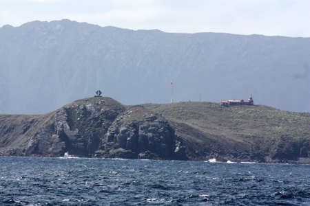View of the monument and the Cape Horn lighthouse from Cape Horn, Chileの写真素材