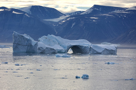 Iceberg with arc in Uummannaq fjord, Greenland, Denmarkの写真素材
