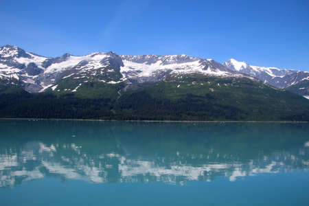 Mountain range reflected in College Fjord, Alaskaの写真素材