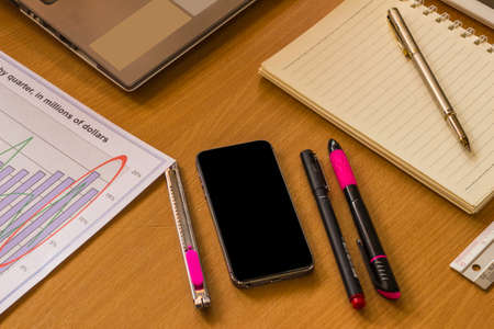 workspace with graph, calculator, stationery and place for textの写真素材