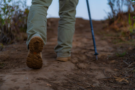 Hikers walk up the mountain, take a break, and drink bottled water.