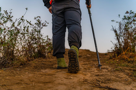 Hikers walk up the mountain, take a break, and drink bottled water.