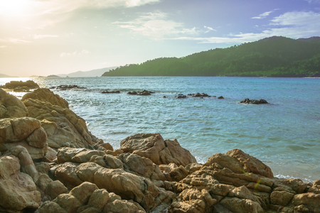 Rock, blue sky, sea and sunlightの写真素材
