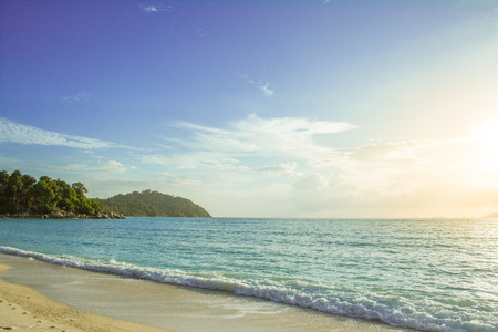 Beautiful seascape wtih blue sky and orange sunlightの写真素材
