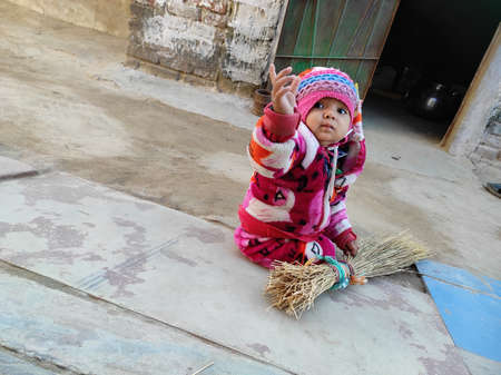 Beautiful Short A Indian Village Baby Girl Playing Photosの写真素材