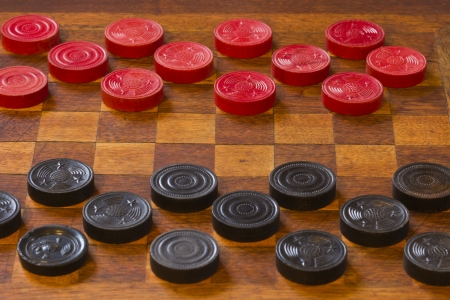 Classic Game of Checkers - Classic Game of Checkers on an Antique Wooden Boardの写真素材