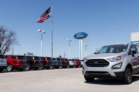 Lafayette - Circa April 2018: Local Ford Car and Truck Dealership with American flag. Ford sells...