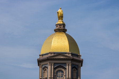 Notre Dame - Circa August 2018: Statue of the Virgin Mary atop the Golden Dome of the University of Notre Dame Main Administration Building IIIのeditorial素材