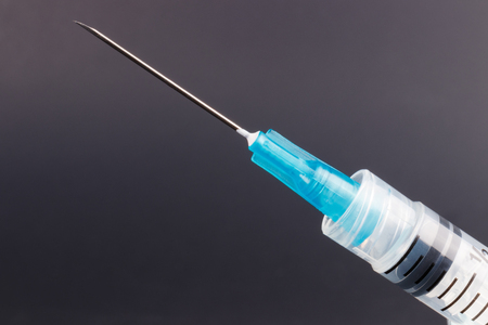 Close up view of a syringe with hypodermic needle. Opiate and heroin overdoses have skyrocketed in recent years Iの写真素材