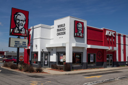 Indianapolis - Circa April 2020: KFC Chicken restaurant. Kentucky Fried Chicken is offering Uber and...